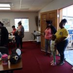 Families and children gather inside a community center during a back-to-school giveaway event.